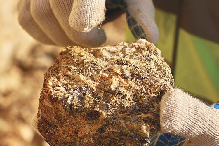 miner holding a sample of mineral