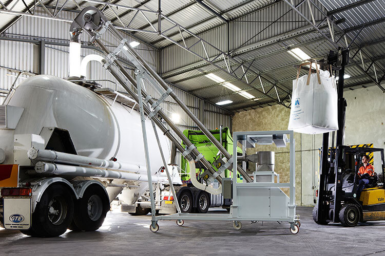 A Floveyor truck loader decanting from a bulk bag discharger